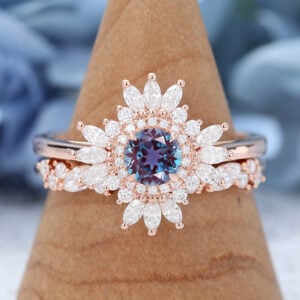The vintage alexandrite bridal ring set features a round alexandrite engagement ring with moissanite halo design and pairing with a moissanite wedding ring, unique and brilliant.
