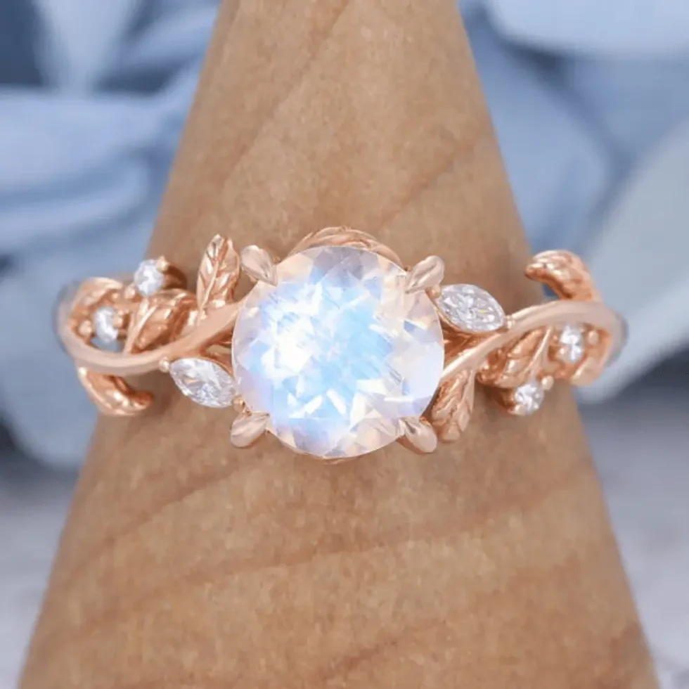 14k Rose Gold Vintage Moonstone Engagement Ring fatures a large round moonstone and nature-inspired rose gold band, which is a rose gold moonstone ring for engagement.