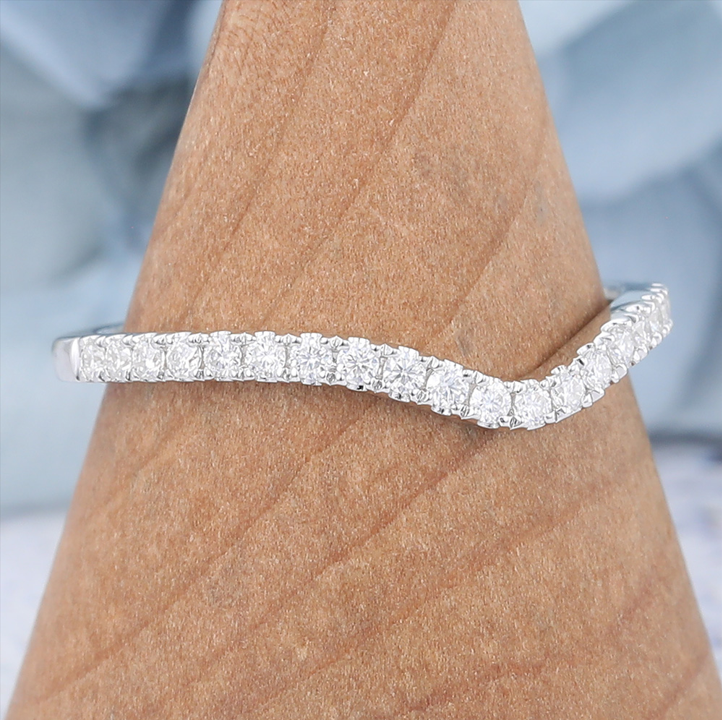 The moissanite wedding bands curved ring features half eternity design and set small carat moissanite on the white gold band, which is a simple but brilliant moissanite wedding ring.
