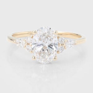 The oval lab grown diamond cluster engagement ring features an oval center stone and round and marqusie cut diamond cluster design.