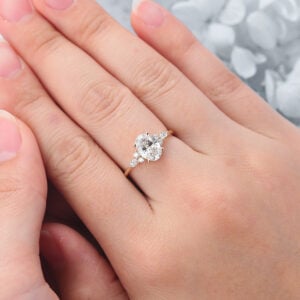 The oval lab grown diamond cluster engagement ring features an oval center stone and round and marqusie cut diamond cluster design.