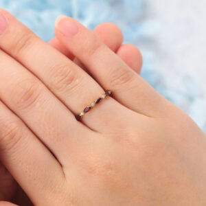 The ruby and moissanite eternity band features alternating marquise-cut rubies and round moissanite stones set on the band, making it a perfect stacking ring for women.