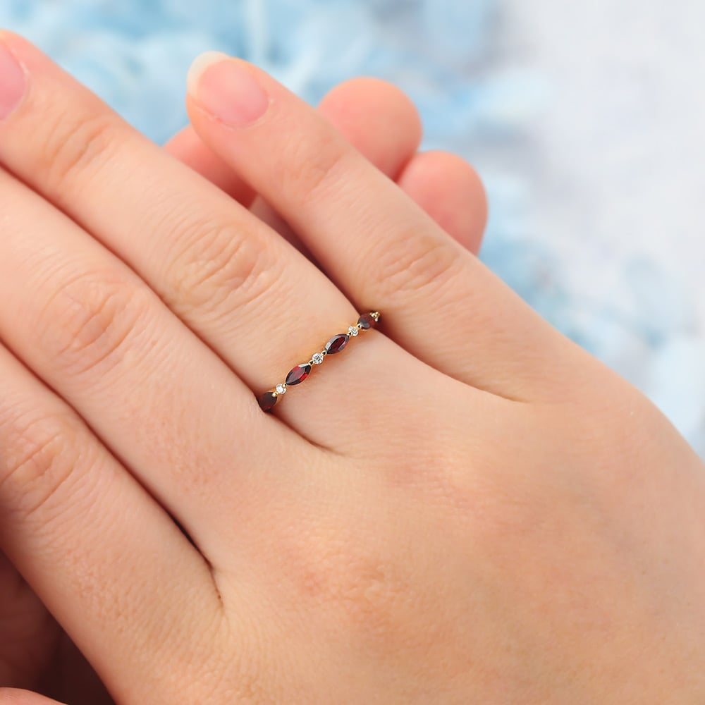 The ruby and moissanite eternity band features alternating marquise-cut rubies and round moissanite stones set on the band, making it a perfect stacking ring for women.