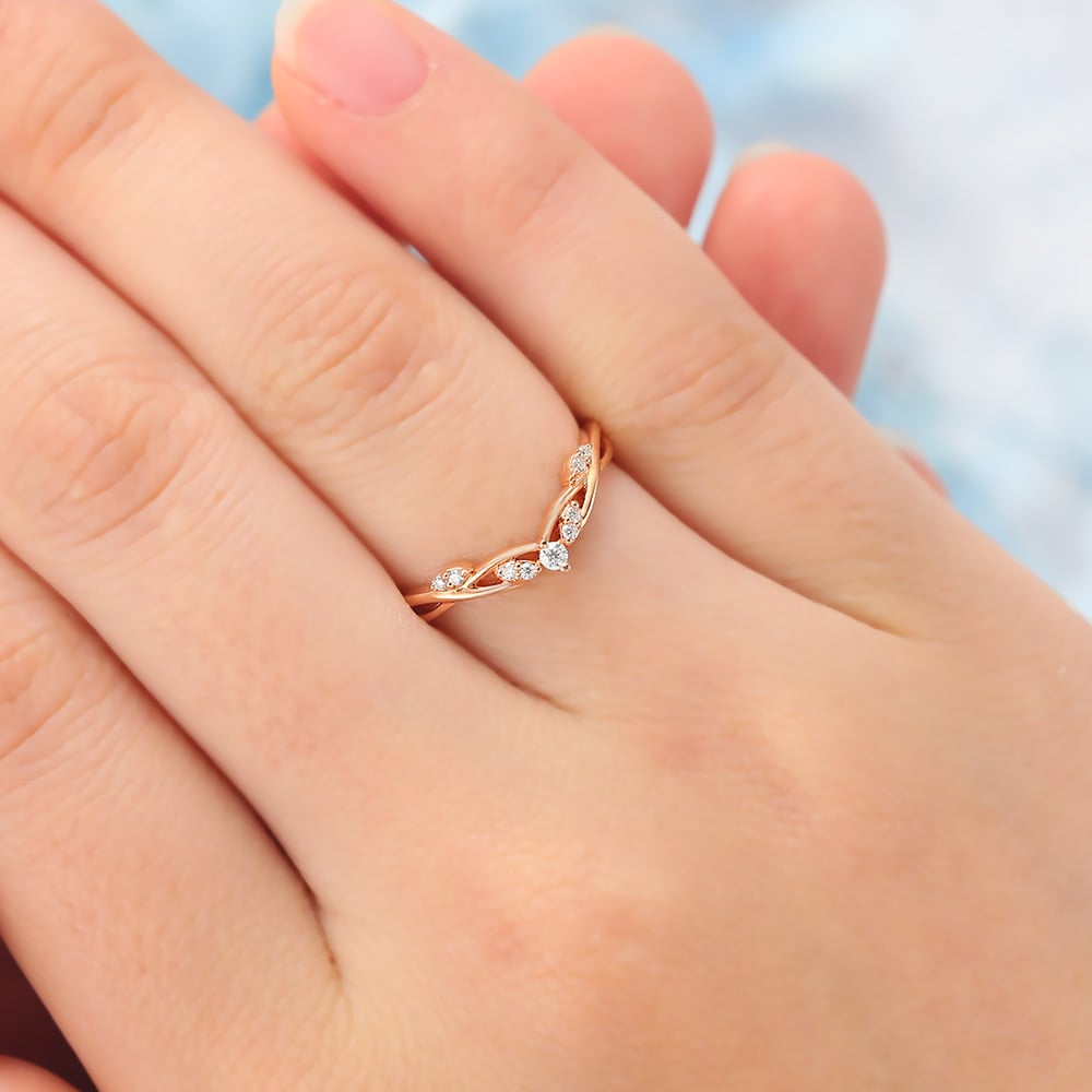 The twisted curved diamond band features small round diamond stones and curved vine design, unique and elegant.