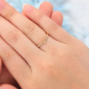 The leaf inspired stacking ring features small carat moissanite stones on the leaf shaped band, which is a unique stacking ring.